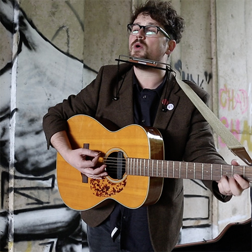 Man sings and plays guitar for social media video produced by VideoHQ