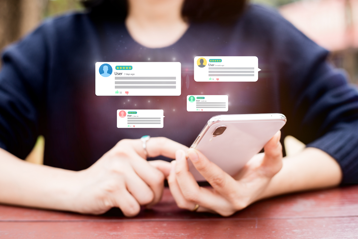 Image of woman tying online reviews from her phone