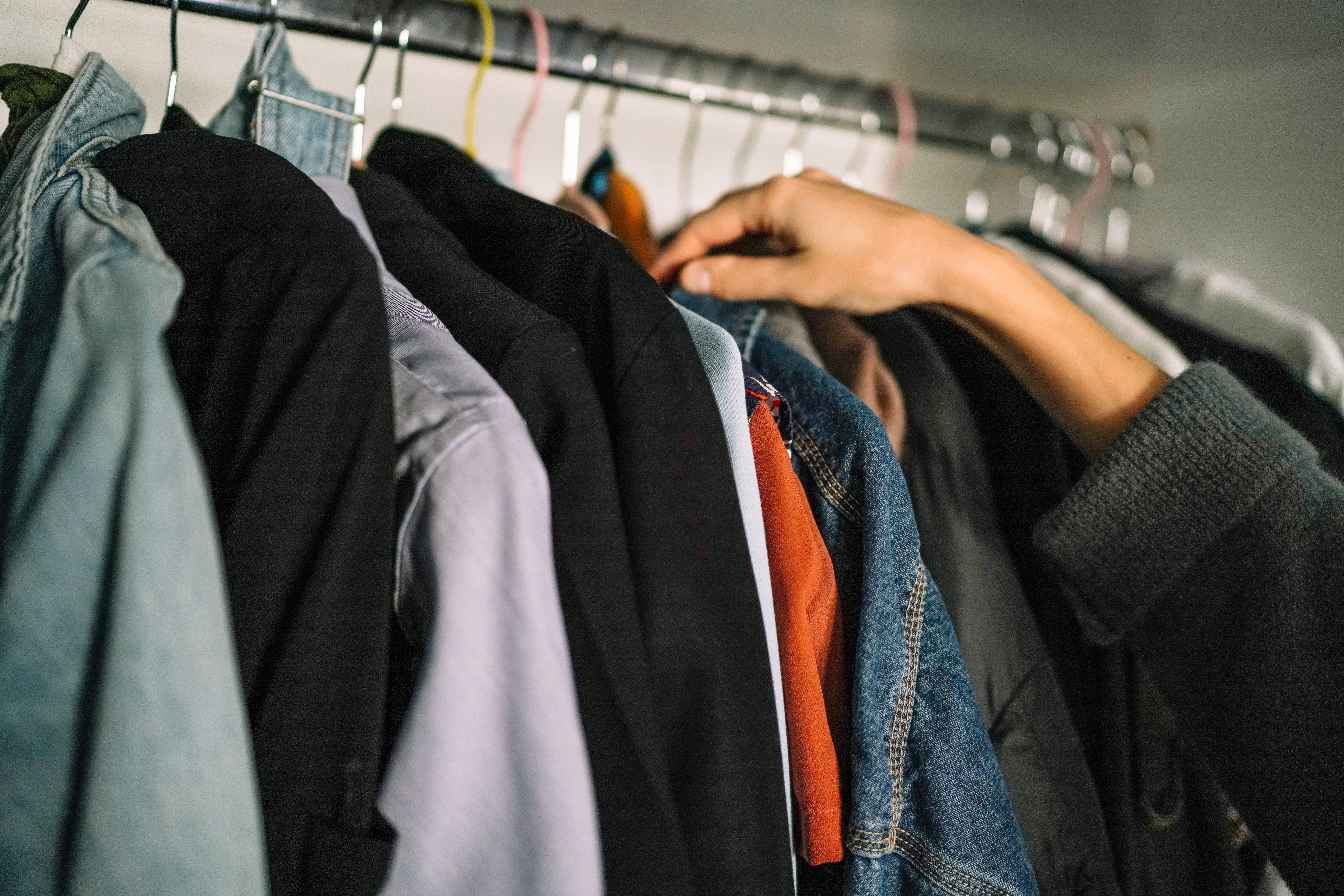 Woman choosing clothes from wardrobe, what do you wear when filming