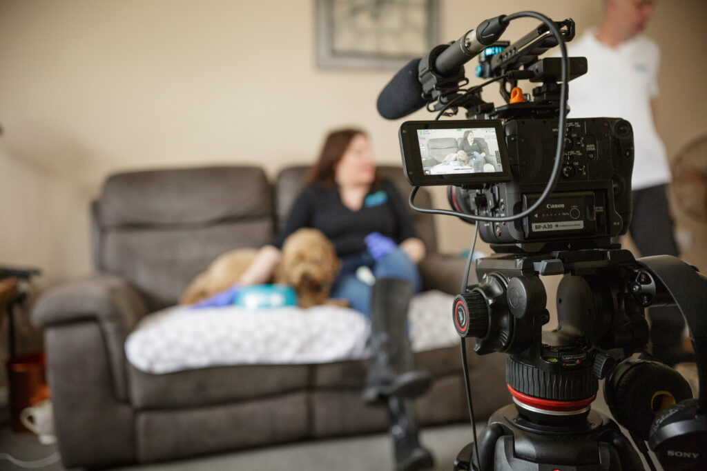 Canon C70 video camera filming dog toothbrush supplier sat on sofa with a dog