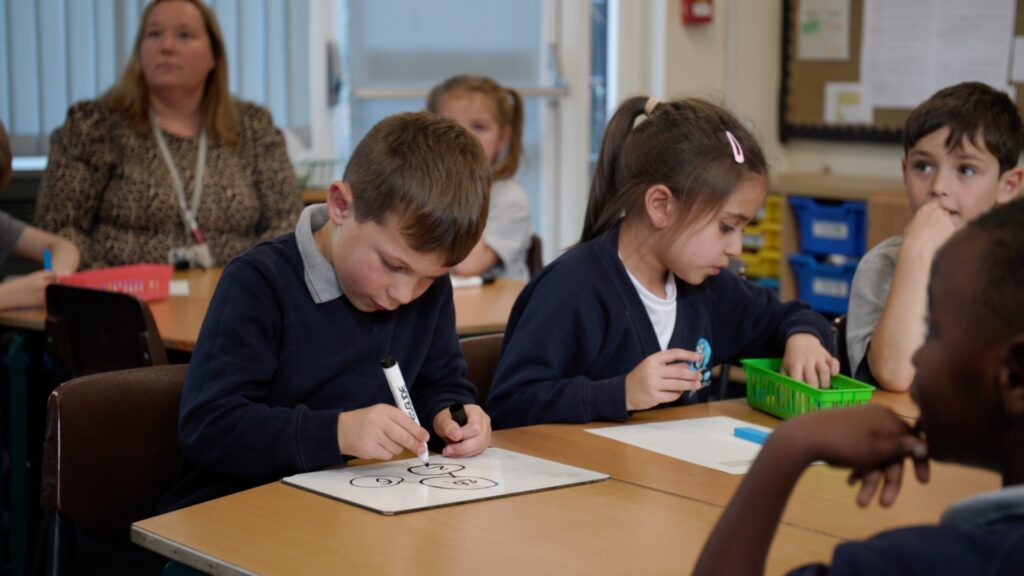 Pupil at Shropshire primary school completing maths problem