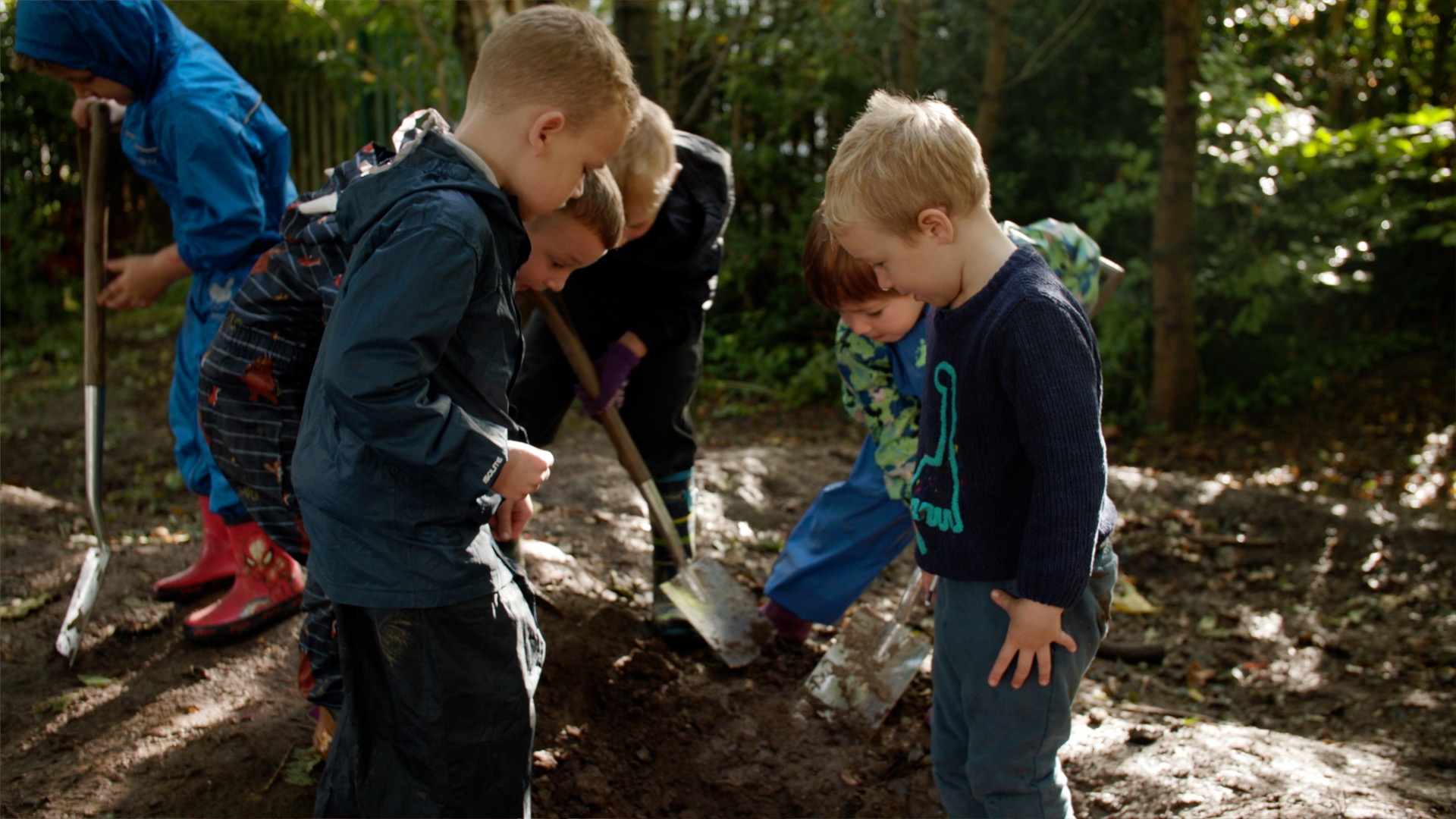 Image shows group of young boys digging during a forest school session at Grange Primary School in Shrewsbury